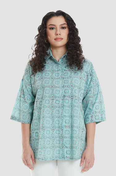 A woman wearing a blue, traditional hand block printed, maharani series top.